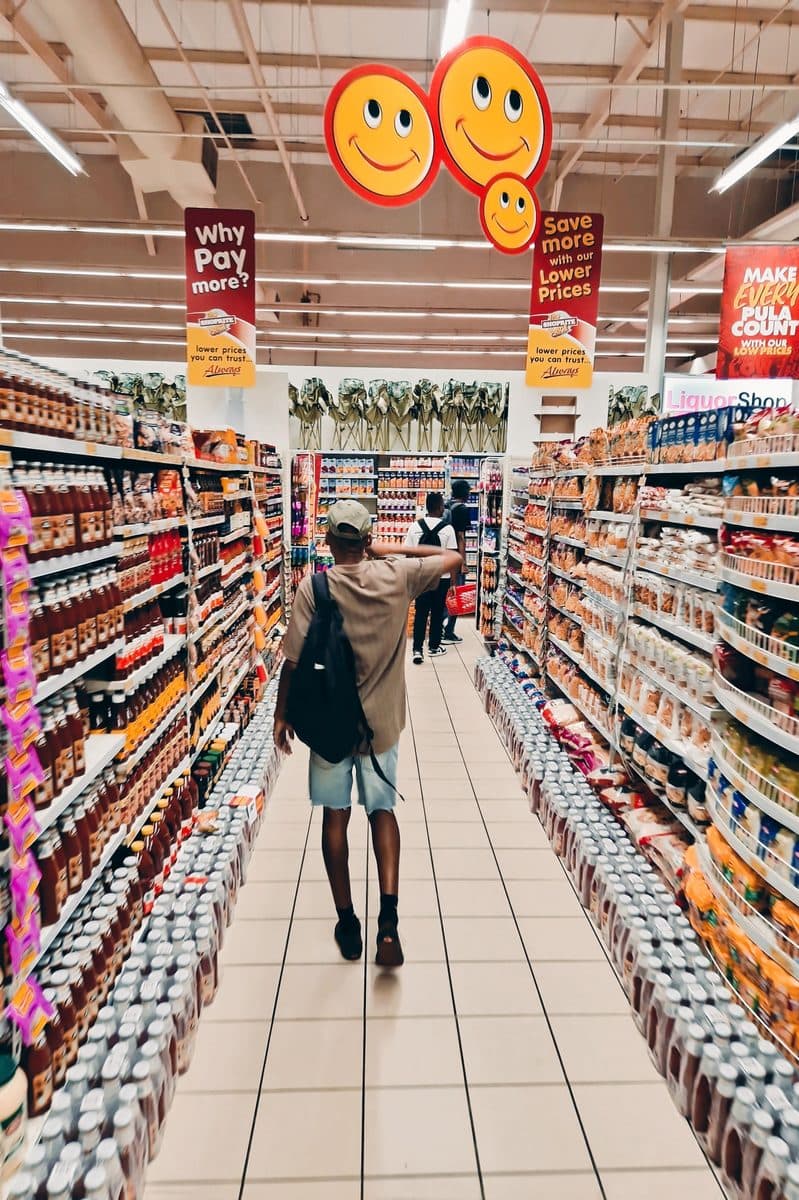 A shopper walking a grocery aisle